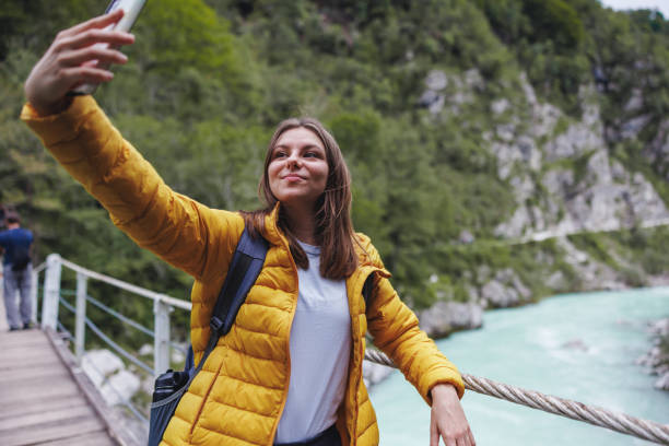 istock Woman Taking Selfie by River During Forest Hike 2152070771