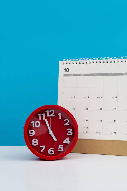 istock Calendar and alarm clock on the table 2152071447