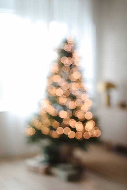 istock Christmas abstract blur background - light bokeh from Xmas tree. Cozy blur bokeh flat apartment room with Christmas Tree, gifts, presents, garlands, decorated interior of living room for New Year 2152072873