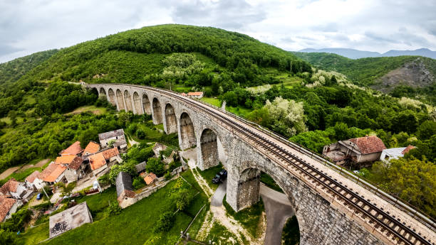 Old train viaduct made from stone crossing the valley, scenic view.