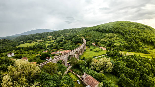 Old train viaduct made from stone crossing the valley, scenic view.