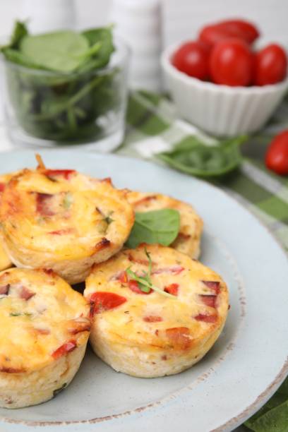 istock Delicious egg muffins with cheese and bacon on table, closeup. Space for text 2152076054