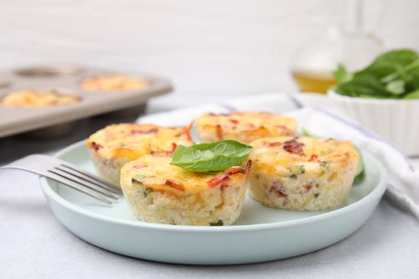 istock Freshly baked bacon and egg muffins with cheese served on table, closeup. Space for text 2152076131