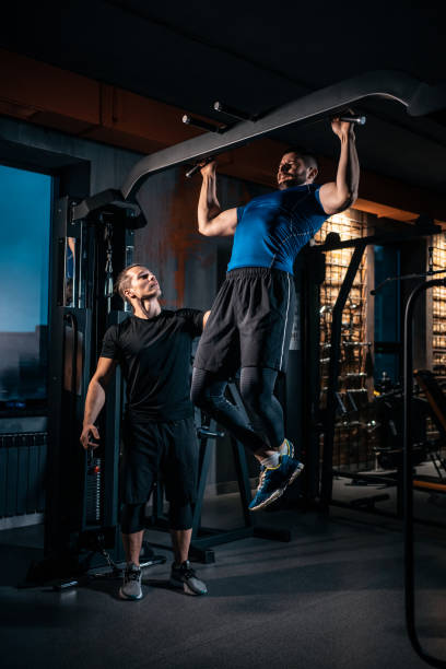 istock young man has workout with personal trainer in modern gym 2152076306