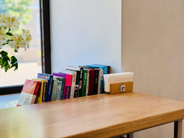 A coffee shop shot with books on big window.