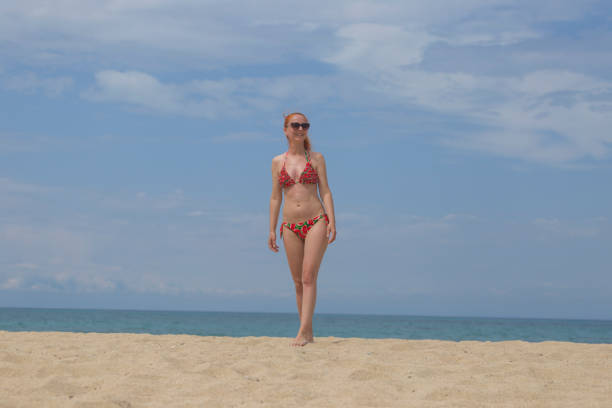 Woman in swimwear enjoy sunny summer day on sand beach
