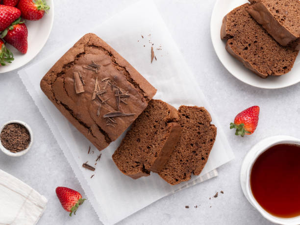 istock Chocolate pound cake. Tea cake sliced and served with black tea cup. Top view table. 2152081591