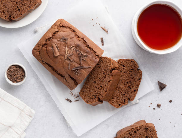 Chocolate pound cake. Tea cake sliced and served with black tea cup. Top view table.
