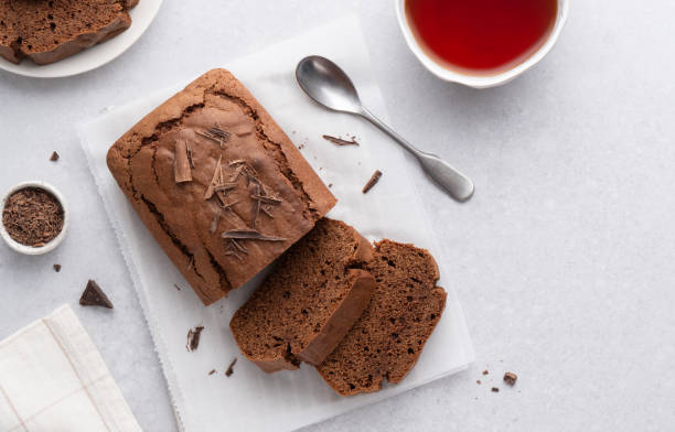 istock Chocolate pound cake. Tea cake sliced and served with black tea cup. Top view table. 2152081595