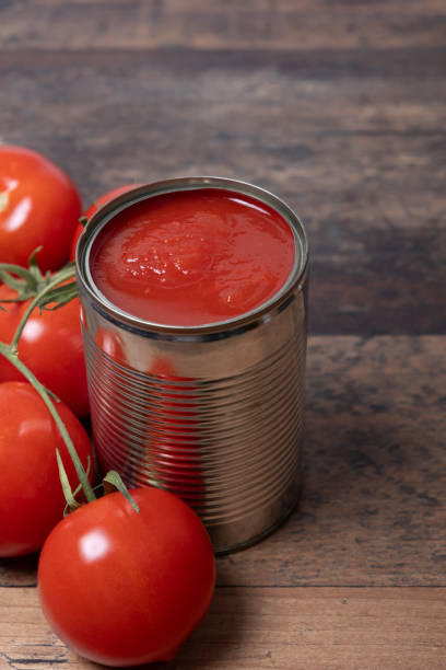 istock Tomato sauce in opened tin can 2152081611
