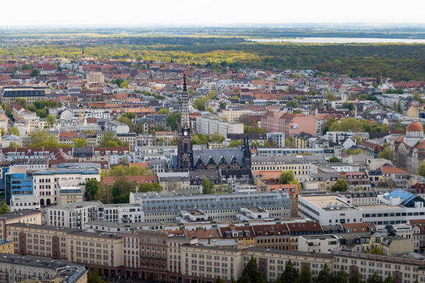 Leipzig, Old St. Peter's Church (Peterskirche) in between the buildings of the city. The architecture is in a Gothic Revival style and it is a travel destination.