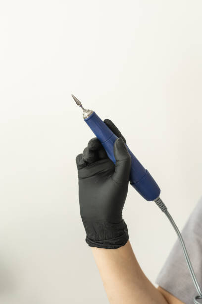 istock Electric nail file drill manicure machine with fraser close up on light background with copy space 2152089060
