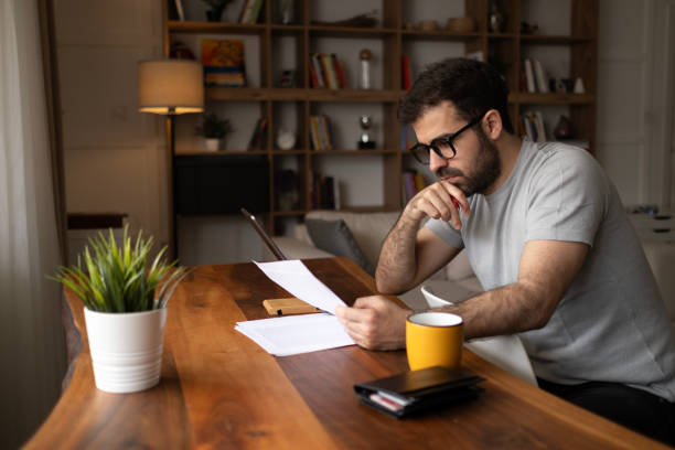 istock Thoughtful young businessman analyzing financial paper data. 2152091867