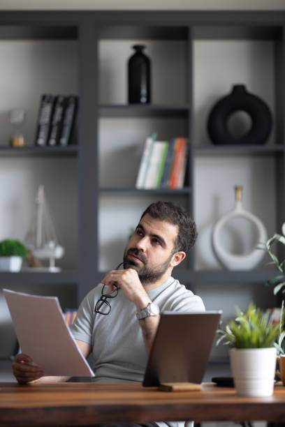 istock Pensive businessman working on laptop while  the office. 2152093117
