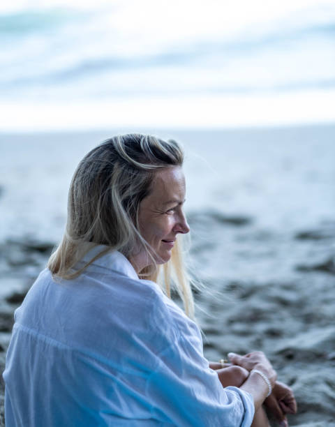 istock beautiful woman on the beach 2152096018