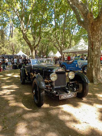 San Isidro, Argentina - Oct 7, 2022: Old black 1932 Aston Martin International sports car under the trees at a classic car show. Copy space