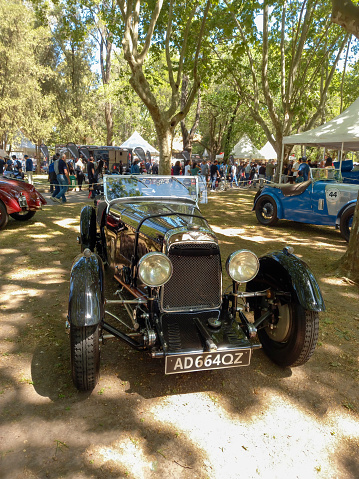 San Isidro, Argentina - Oct 7, 2022: Old black 1932 Aston Martin International sports car under the trees at a classic car show.