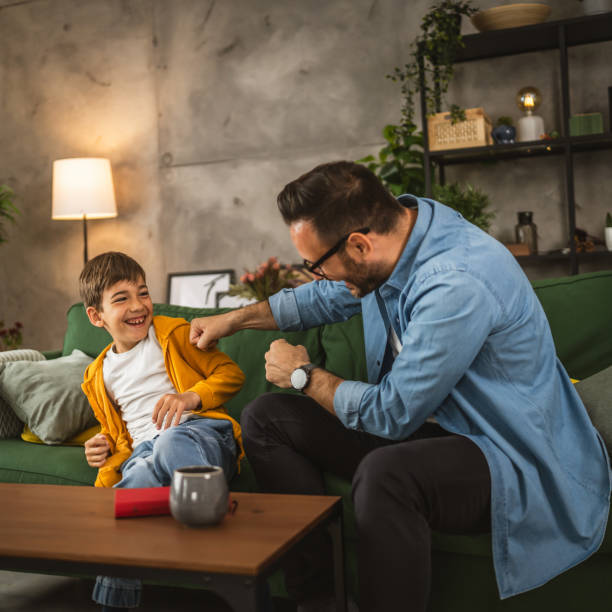 istock Dad and son take a break from read teasing each other and have fun 2152099248