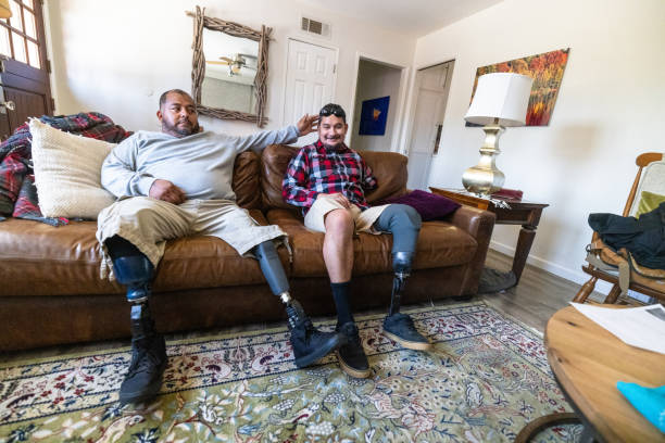 istock Disabled hispanic veteran amputees hanging out at home 2152102582