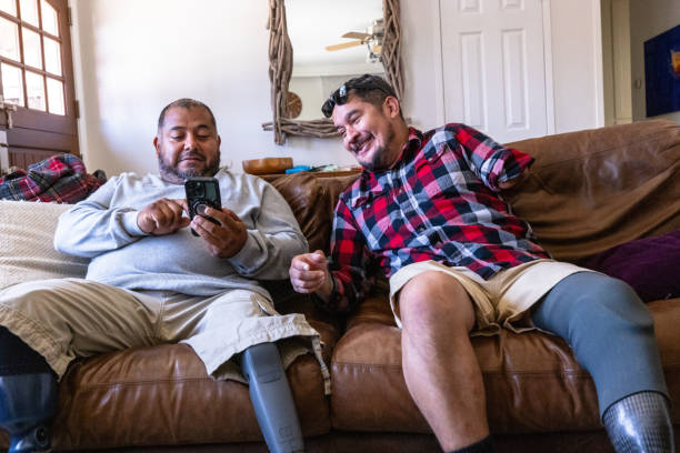 istock Disabled hispanic veteran amputees hanging out at home 2152102731
