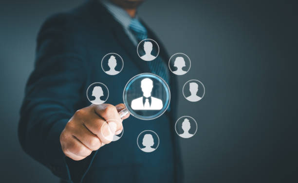 istock Human resource management concept. Businessman uses magnifying glass look employees teamwork business or Customer Relation Management focus target group social media. Digital marketing online. CRM 2152104084