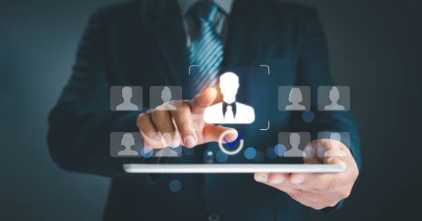 istock Human resource management concept. Businessman holding virtual human icon on hand choose employees fo teamwork Customer Relation Management focus target group social media. Digital marketing online. 2152104085