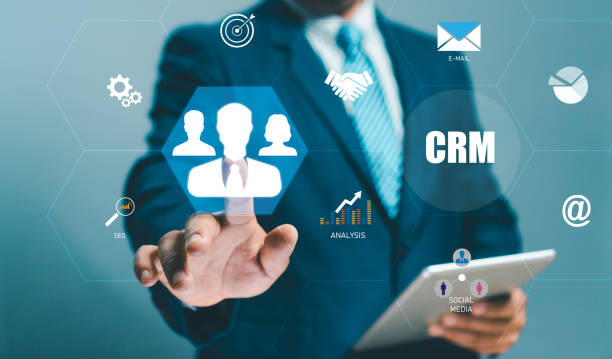 istock CRM or Customer Relation Management and customer service concept. Businessman holding virtual human icon on hand customer focus target group use social media technology, Digital marketing online. 2152104091