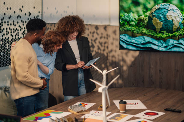 istock Happy diverse staff at office with tablet working on pollution reduction 2152105882