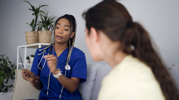 istock Latin female GP doing home visit. Home caregiver. 2152106569