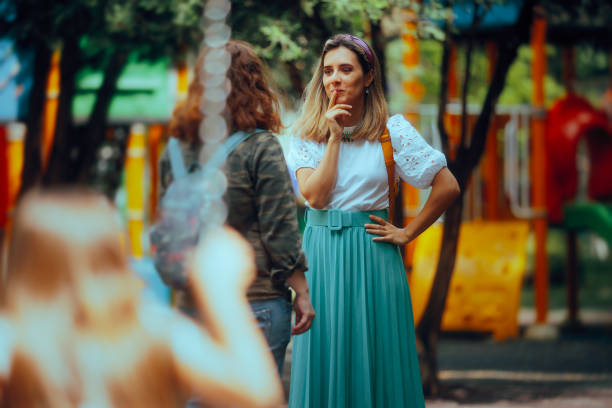 Mothers Talking at the Playground While Kids Play in Swings