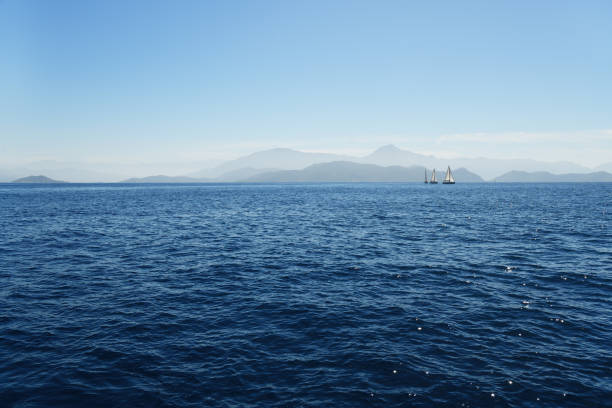 Sailing cruise in Turkey. Three beautiful white yachts, sailboats or sail boats sailing at sea on a calm, bright sunny day