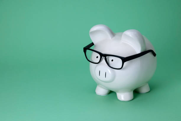 istock White Piggy Bank on a Mint Green Background 2152115434