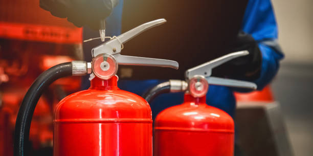 istock Engineer check fire extinguisher tank in the fire control room for safety in factory or industry. 2152117256