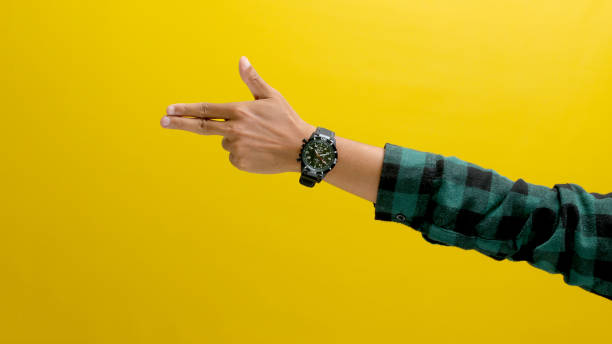 istock Hand makes a finger gun gesture on a yellow background 2152117672