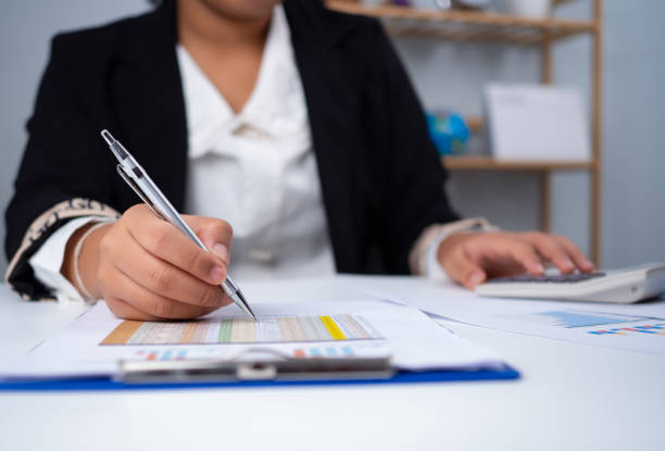 istock Business woman people use computers and paper documents to analyze business and manage corporate information. Business analysis with charts, indicators, and KPIs to improve organizational performance. 2152117792