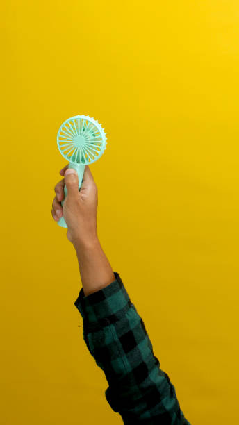 istock Hand holding small portable fan 2152118452