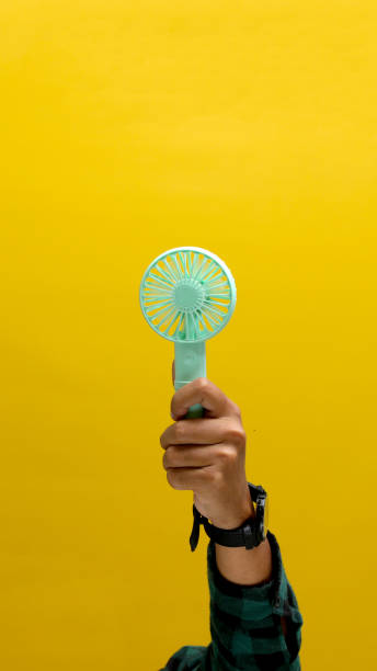 istock Hand holding small portable fan 2152118456