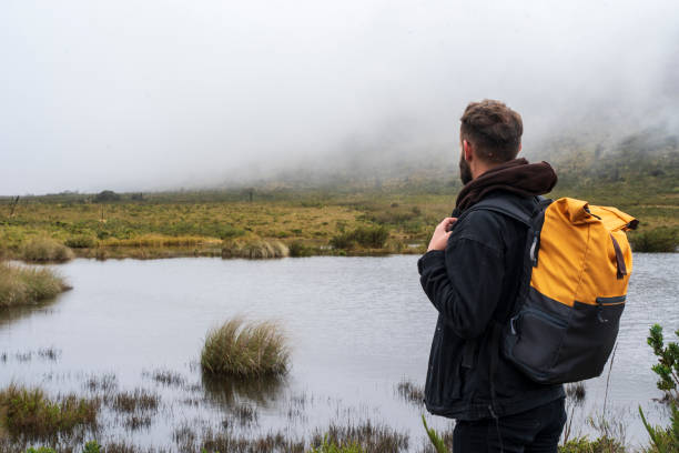 istock Millennial generation man admiring the cold and beautiful landscape on a quick trip with his camera and backpack 2152119470