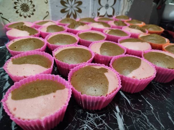 istock Steamed strawberry vanilla cake that has been cooked in a pink mold on a black marble table. 2152119673