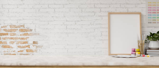 istock A white tabletop features painting tools and display space against the white brick wall. 2152119820