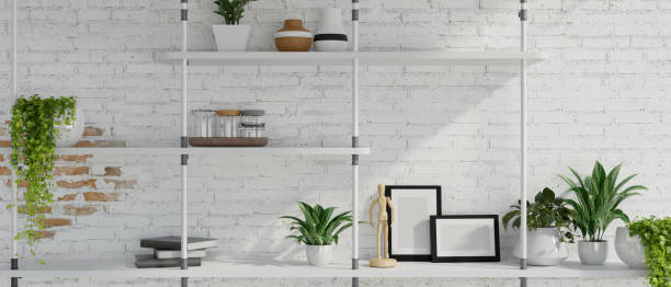 istock A minimal rustic white brick wall with a modern wall shelf, home decor, and houseplant in pots. 2152119932