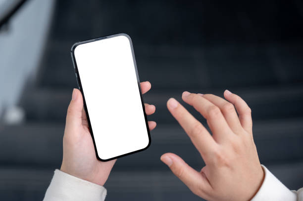 istock A close-up image of a woman using her smartphone while walking down the stairs. 2152120056
