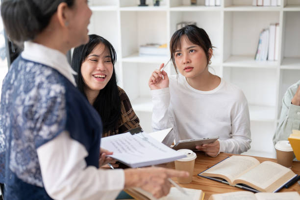 istock A doubtful young Asian female student is listening to her teacher explaining a difficult topic. 2152120572