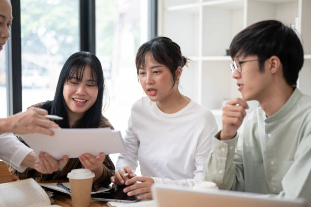 istock A group of Asian university students is studying math with a senior professor in the classroom. 2152120597