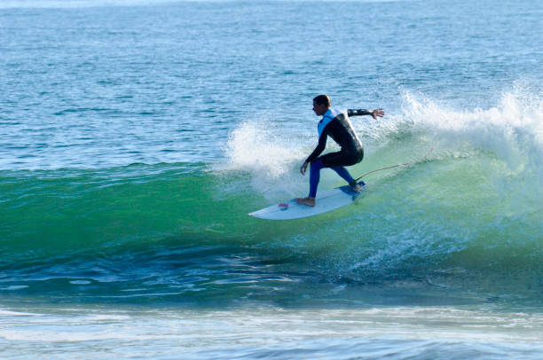 istock Surfer at Speed Races the Curl on a Sunlit Wave 2152121980