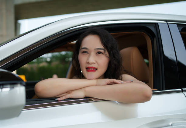 istock Beautiful woman sitting in car 2152125246