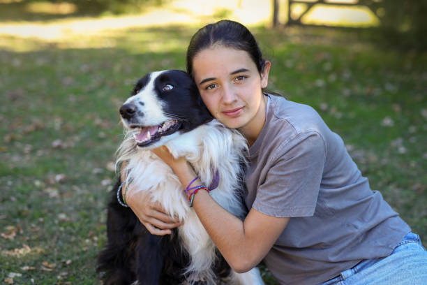 istock Hispanic girl hugging her dog 2152126292