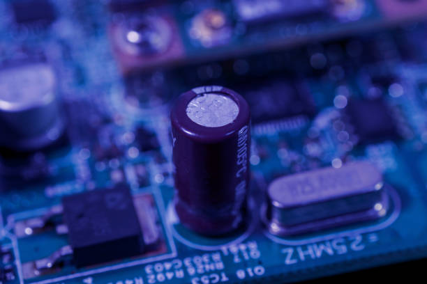 Close-up image reveals intricate details of a circuit board. It features components like capacitors, microchips, and soldered connections. The circuit board is a critical part of electronic devices
