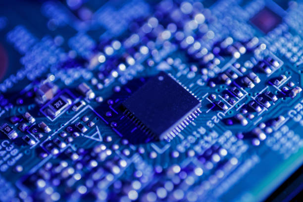 istock Green circuit board with a black integrated circuit chip and various small electronic components 2152127329