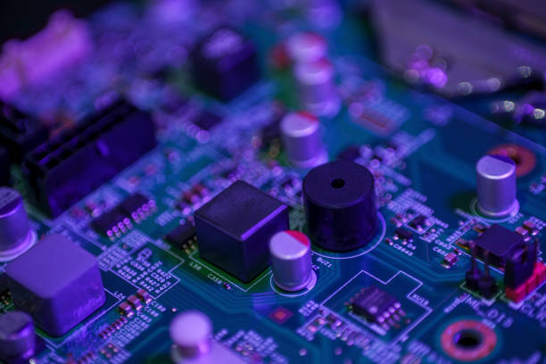 istock Green circuit board with a black integrated circuit chip and various small electronic components 2152127335